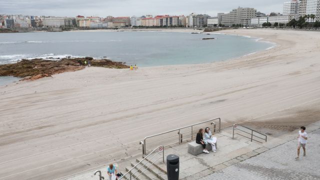 La playa de Riazor tras la recogida de basura por parte de los equipos de limpieza.