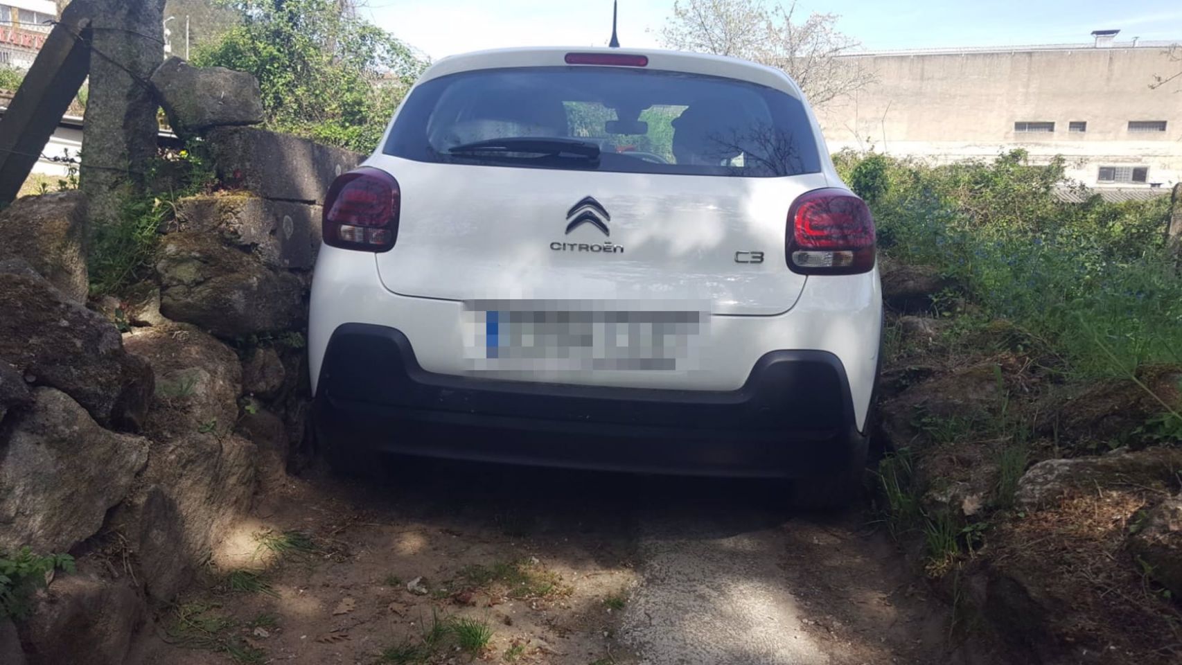 El vehículo atrapado en un camino rural de Ourense.